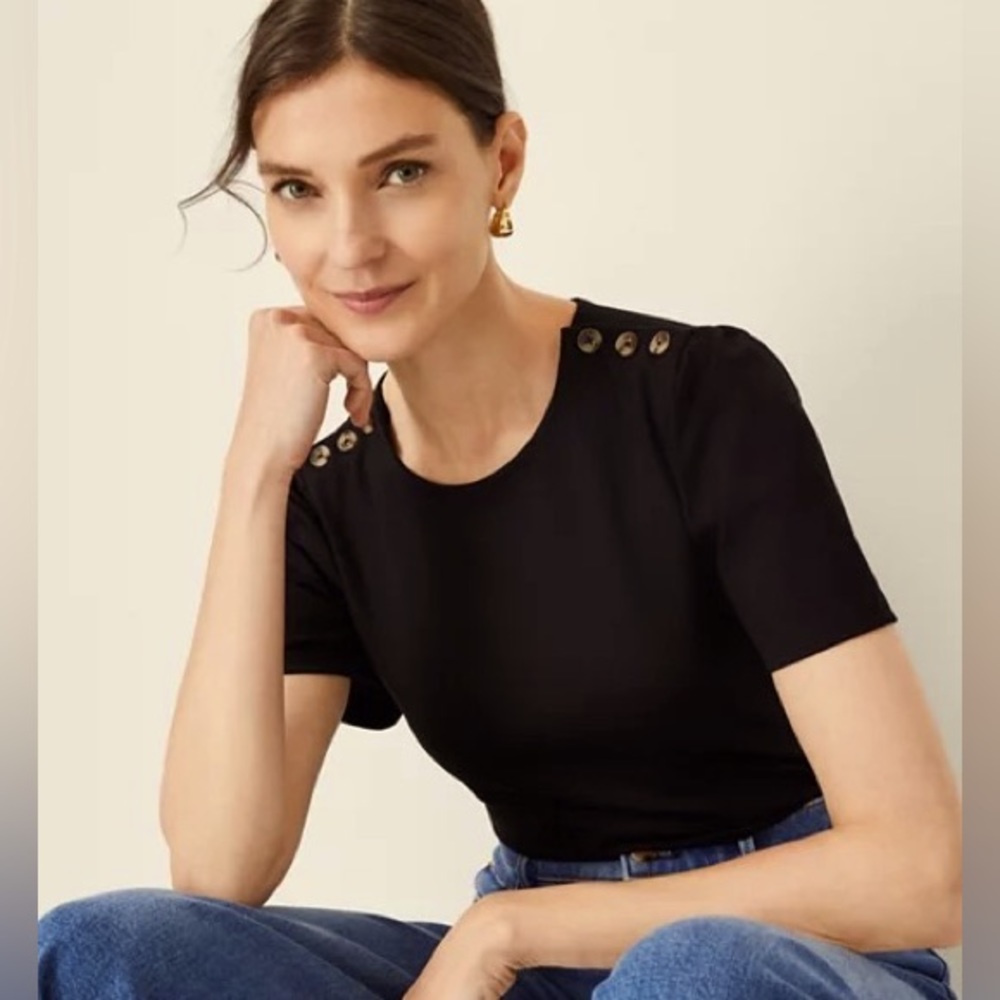 New top with a cute Flutter short sleeve and buttons on the shoulders.